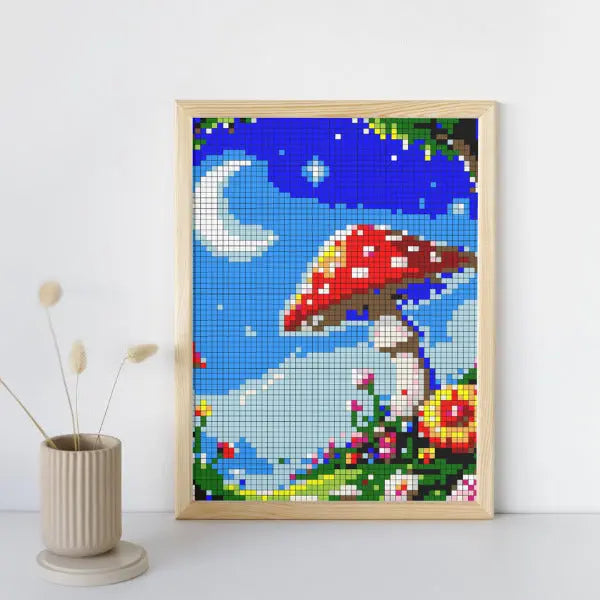 A framed color by number artwork depicting a whimsical moonlight garden scene with a large red mushroom and a crescent moon, created with a mosaic pattern, displayed on a white surface.