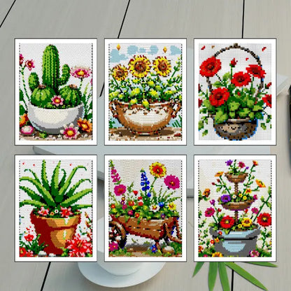 Six colorful completed color by number mosaic art pieces featuring various flower and plant pots, including a cactus, sunflowers in a bowl, red poppies in a hanging basket, an aloe plant, a wheelbarrow with mixed flowers, and a tiered planter with blooms.