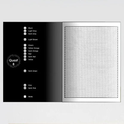 An open color by number book showing a page with a color key on the left and a blank mosaic pattern on the right.
